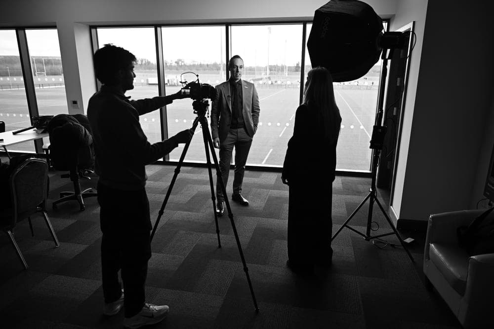 Jeff Gomez being interviewed on camera at a training ground